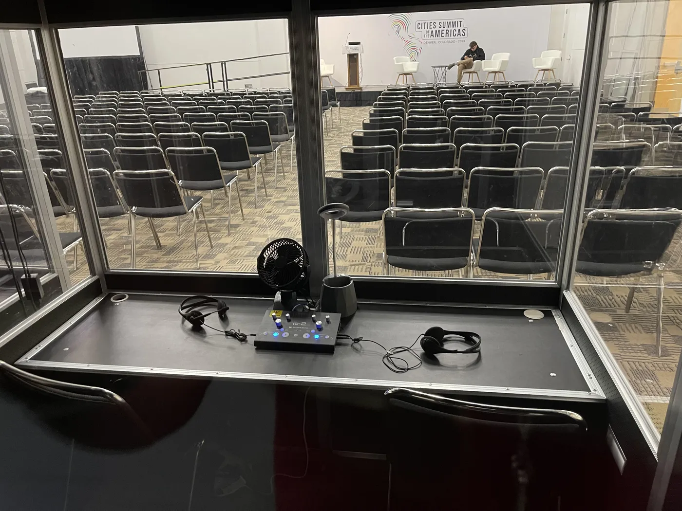 Interpreters working in a conference interpreting booth
