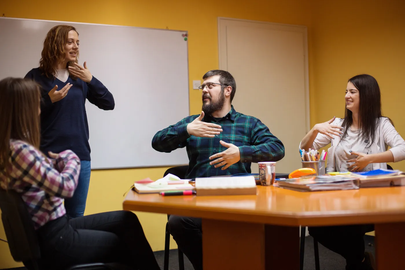 An ASL interpreter signing in a meeting