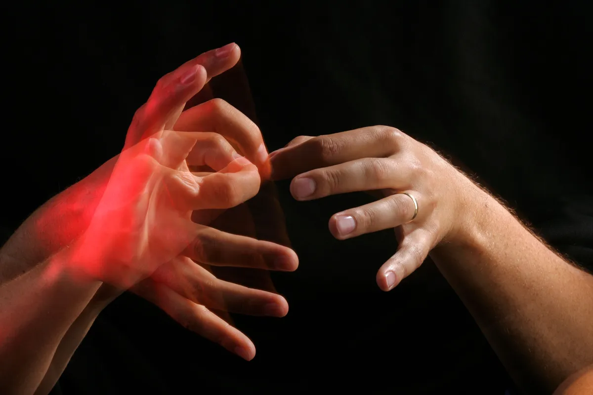Two pairs of hands communicating through touch