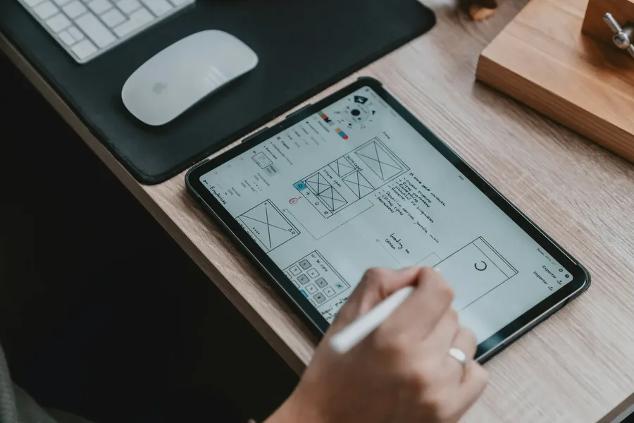 An engineer marking up a technical drawing on a tablet