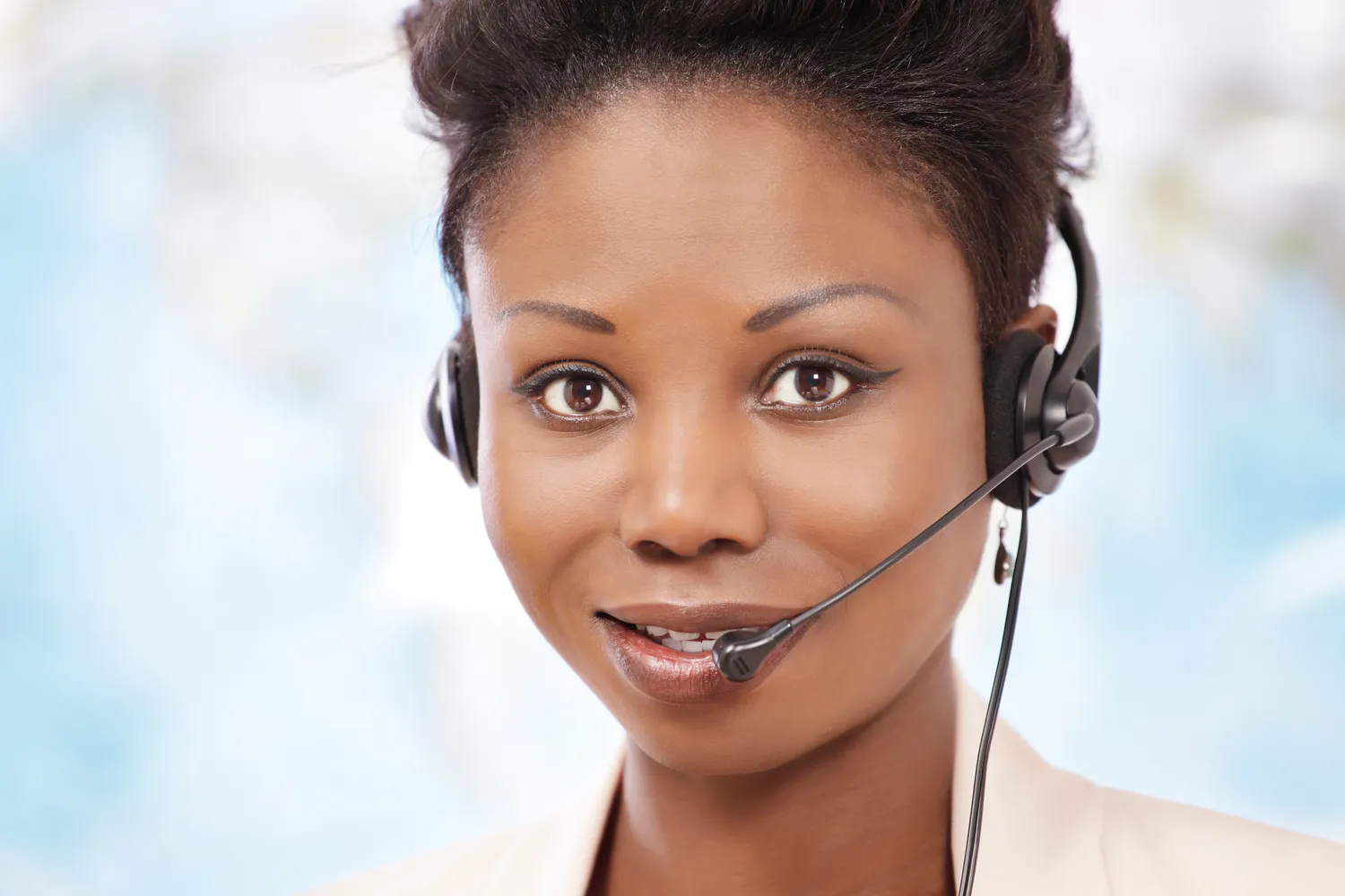 A phone interpreter wearing a headset listens carefully during a call